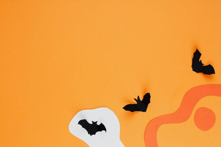 Papierowe nietoperze na intensywnie pomarańczowym tle Halloween